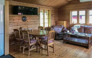 a living room with a table and chairs and a couch at Lovely Home In Trngsviken With Kitchen in TrÃ¥ngsviken