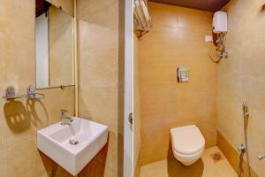 a bathroom with a sink and a toilet at FabExpress Diamond I in Mumbai