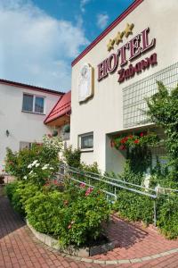 ein Hotel mit Blumen vor einem Gebäude in der Unterkunft Hotel Zabawa in Zabawa