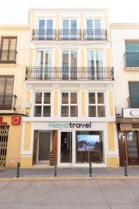 a large white building with a top travel sign on it at La Paz in Almansa
