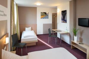 A bed or beds in a room at Hotel Mainstation