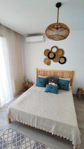 a bedroom with a large bed with blue pillows at Ideal Appart la Marsa Jade Résidence de Luxe in La Marsa