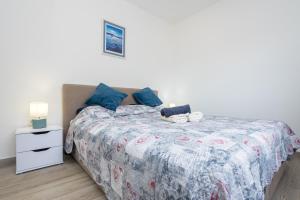 a bedroom with a bed and a white night stand at Apartment Kristina by EL-PI Tours in Županje