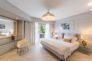 a bedroom with a large white bed and a window at St George Lycabettus Lifestyle Hotel in Athens