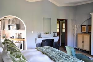 a living room with a bed and a fireplace at Cherry Grove 2 in Dullstroom