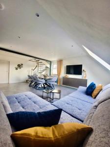 a living room with two blue couches and a tv at Blissberg Winterberg in Winterberg