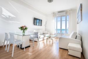 a white living room with a table and chairs at SEA FRONT - Panoramic view with Terraсe - 2BR in Nice