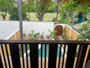 a balcony view of a yard with a pool at La Villa Loca in Gili Air