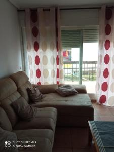 a living room with a couch and a window at Apartamento PUERTO REY 2 in Vera