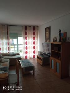 a living room with a couch and a tv at Apartamento PUERTO REY 2 in Vera