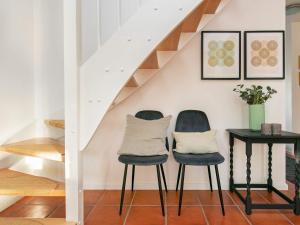 ブラーバンドにある4 person holiday home in Bl vandの階段付きの部屋(椅子2脚、テーブル1台付)