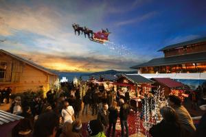 a crowd of people standing around a christmas market at Sunset House with gorgeous view of the lake in Montreux