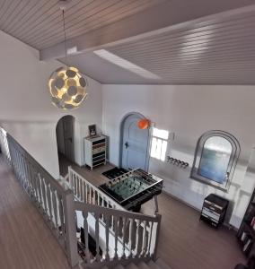 a living room with a staircase and a pendant light at Sunset House with gorgeous view of the lake in Montreux