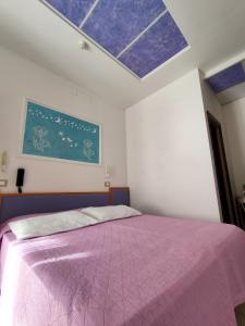 A bed or beds in a room at Albergo Eva