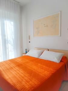 A bed or beds in a room at Albergo Eva