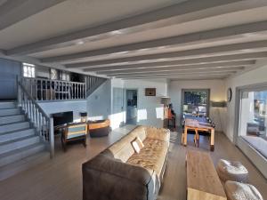 a living room with a couch and a table at Sunset House with gorgeous view of the lake in Montreux