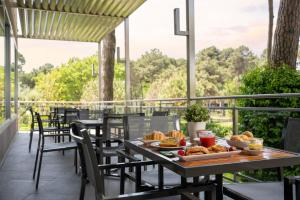 a table with food on it on a patio at Hotel Embassy & Boston in Milano Marittima