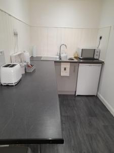 a kitchen with a sink and a counter top at riverside rooms at wheelgate house in Goole