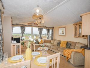 a living room with a couch and a table at Mountain View Lodge in Holyhead