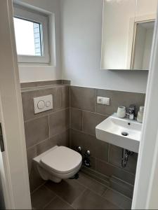 a bathroom with a toilet and a sink at Schöne Wohnung nahe Köln in Cologne