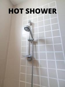 a shower in a bathroom with the words hot shower at Heritage 12 Homestay Studio 4Pax Free WIFI Netflix in Seri Kembangan