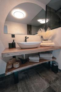 a bathroom counter with a sink and a mirror at Appartement Reichholf in Bramberg am Wildkogel