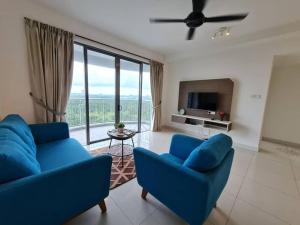 a living room with two blue couches and a tv at 2 bedder Seaview condo with Wifi near Legoland for 6 pax in Nusajaya