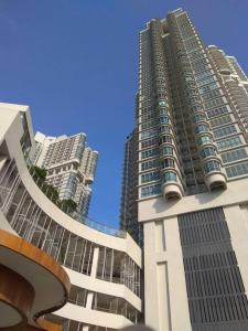 two tall buildings in front of a blue sky at 2 bedder Seaview condo with Wifi near Legoland for 6 pax in Nusajaya