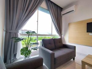 een woonkamer met een bank en een groot raam bij Queensway ONE Homestay 10Pax 3Rooms in Sibu