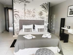 a bedroom with a large bed with towels on it at Villa Prado Sanary in Sanary-sur-Mer