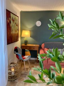 a living room with a couch and a chair at La Belle Demeure in Saint-Cybranet