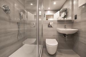 a bathroom with a shower and a toilet and a sink at Park Avenue Bayswater Inn Hyde Park in London