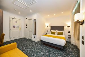 a hotel room with a bed and a couch at Park Avenue Bayswater Inn Hyde Park in London +95 photos