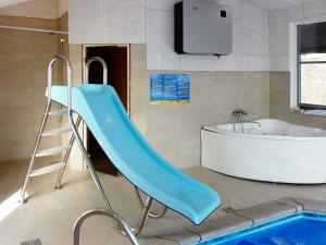 - un toboggan bleu dans la salle de bains à côté d'une baignoire dans l'établissement 8 person holiday home in Ebeltoft, à Ebeltoft