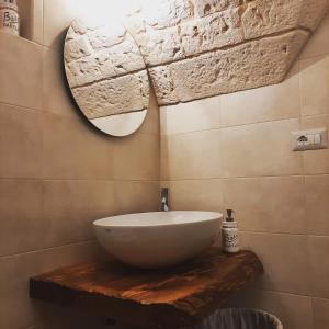 a bathroom with a bowl sink and a mirror at Lumè in Putignano +28 photos