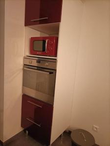 a kitchen with a microwave and a stove at la maison du bonheur in Saint-Germain-Laval