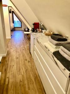 a kitchen with white cabinets and a wooden floor at Eagle's Nest in Breuil-Cervinia