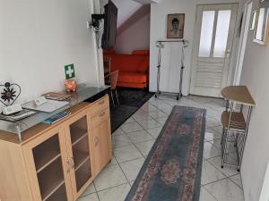 a living room with an orange couch and a table at Panorama Apartman in Molvice