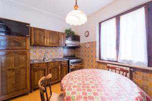 una cucina con tavolo, lavandino e finestra di Villa Campo al Pero a Rio Marina Altre 31 foto