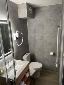 a bathroom with a toilet and a sink at Hotel De Clisson Saint Brieuc in Saint-Brieuc