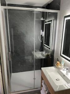 a bathroom with a shower and a sink at Hotel De Clisson Saint Brieuc in Saint-Brieuc