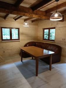 a living room with a couch and a table at Dom Sosnowy in Szczytno