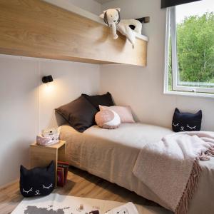 een kleine slaapkamer met een bed en een raam bij Parc de vacances La Draille in Souillac