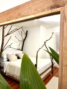 a bedroom with a canopy bed with a tree at VILLA NEYRA 