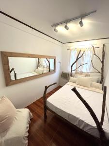a bedroom with two beds and a mirror at VILLA NEYRA 