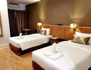 Postel nebo postele na pokoji v ubytování Manomon residence มโนมน เรสซิเดนซ์