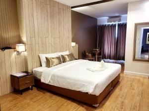 Postel nebo postele na pokoji v ubytování Manomon residence มโนมน เรสซิเดนซ์