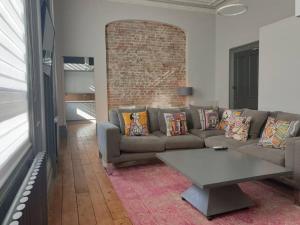 a living room with a couch and a table at 22 Stunning Large Loft - Great Location - Free Onsite Parking - Garden View- Quiet - Sleeps 3 in Brighton & Hove