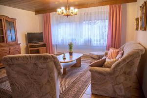 a living room with two chairs and a table at Ferienhaus Fisch 