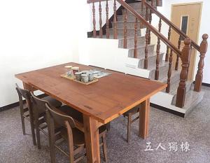 南竿鄉的住宿－沐光獨棟館，楼梯旁的一张带椅子的木桌